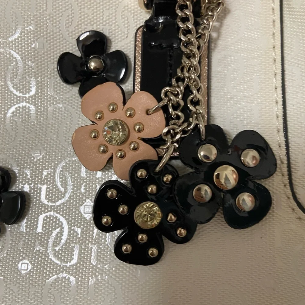 Guess purse cream w black flowers useful but well loved $49